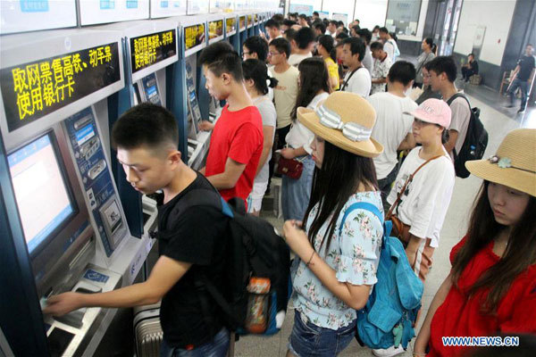Passengers take tickets from the ticket vending machines at Suzhou Railway Station in Suzhou City, east China's Jiangsu Province, August 31, 2017. China's summer transport peak period ran from July 1 to August 31, when students on summer vacation had time to travel or return home. [Photo: Xinhua/Wang Jiankang]