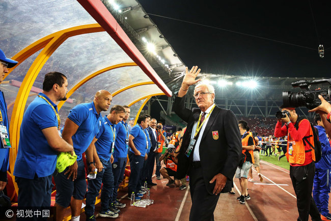 Marcello Lippi, head coach of China men's national football team,  waves to audience in Wuhan 