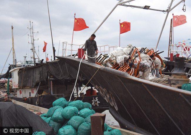 Fishing boats return to the port to take shelter ahead of Typhoon Talim in Taizhou, Zhejiang province, September 11, 2017. [Photo: VCG]