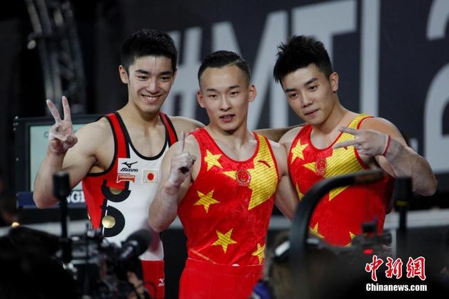 Chinese gymnasts Xiao Ruoteng (C), Lin Chaopan (R) and Japanese gymnast Shirai Kenzo pose for photos before the awards ceremony in the men's all-around at the Artistic Gymnastics World Championships in Montreal, Canada on Thursday, October 5, 2017. China swept both gold and silver medals for the first time in the Artistic Gymnastics World Championships. [Photo: Chinanews.com]