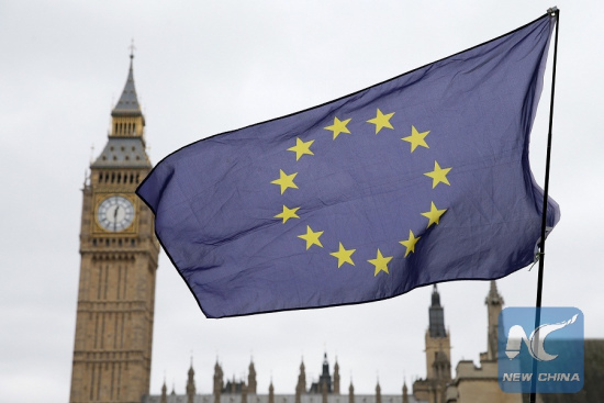 An EU flag is seen outside the Houses of Parliament in London, Britain on March 29, 2017. [Photo: Xinhua]