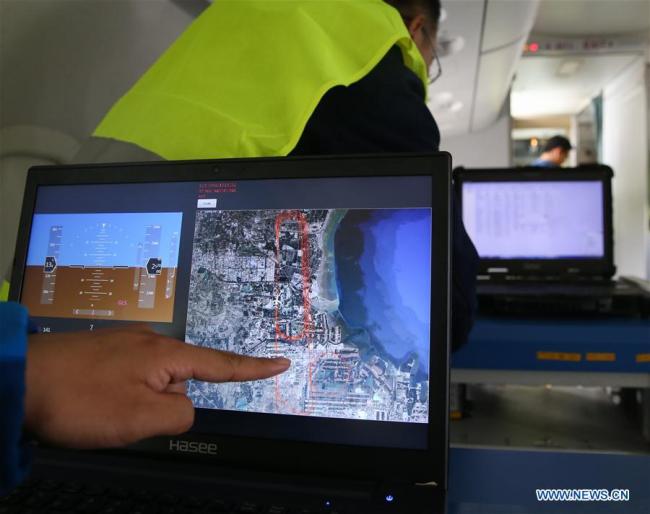 A staff member shows the flight path drew by the BeiDou navigation system on an ARJ21-700 plane during a test flight in Dongying, east China's Shandong Province on October 14th, 2017. The Chinese-developed regional jetliner, which has the BeiDou navigation system installed, has successfully completed a test flight, the Commercial Aircraft Corporation of China (COMAC) said Saturday. [Photo: news.cn]