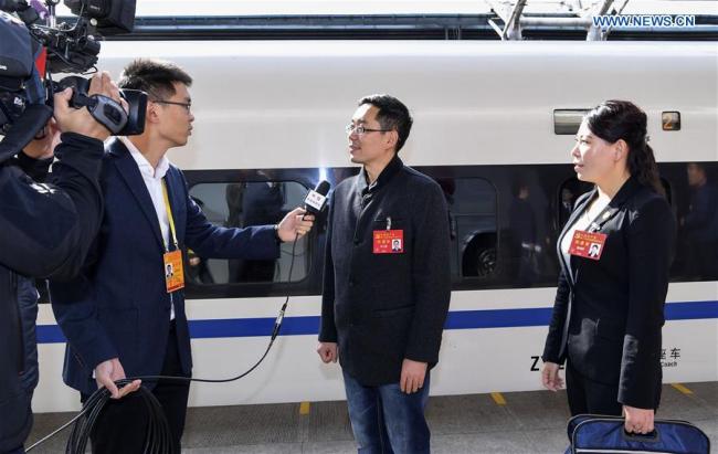 Zhang Xuesong (2nd R) and Chen Linjing (1st R), delegates of Hebei Province to the 19th National Congress of the Communist Party of China (CPC), receive interviews upon their arrival in Beijing, capital of China, Oct. 16, 2017. Delegates of Hebei Province to the 19th CPC National Congress arrived in Beijing on Monday. The congress will start on Oct. 18 in Beijing. [Photo: Xinhua]