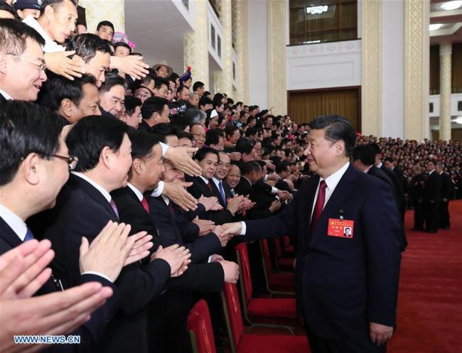  Xi Jinping, general secretary of the Communist Party of China (CPC) Central Committee, meet s with more than 2,700 delegates, specially invited delegates and non-voting participants of the 19th CPC National Congress in Beijing, on October 25, 2017. [Photo: Xinhua]