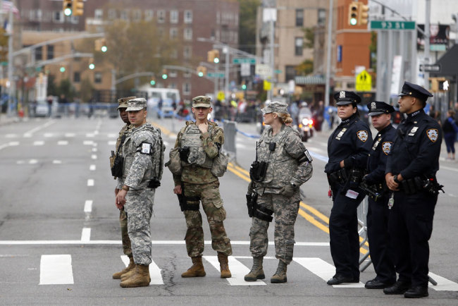 National Guard troops and police stand watch along the course during the New York City Marathon, Sunday, Nov. 5, 2017, in New York. [Photo: AP/Jason DeCrow]