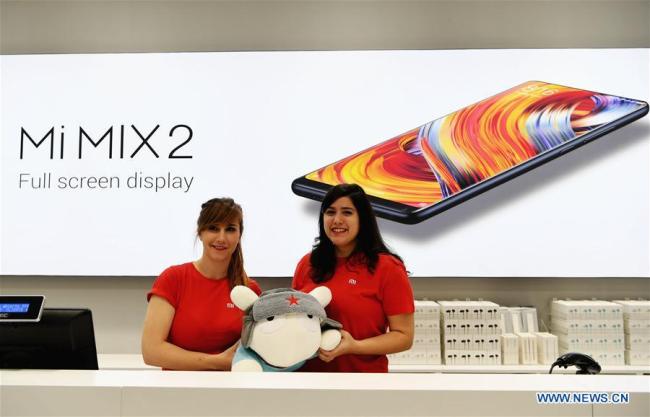 Staff members present a Xiaomi doll at a store in Madrid, capital of Spain, on Nov 11, 2017. Xiaomi, one of the leading high-tech enterprises of China, opened on Saturday morning its two stores via its authorized re-sellers in Madrid. [Photo: Xinhua]