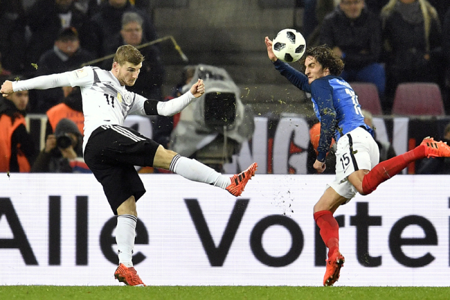 Germany's Timo Werner, left, kicks the ball against France's Adrien Rabiot, right, during an international friendly soccer match between Germany and France in Cologne, Germany, Tuesday, Nov. 14, 2017. [Photo: AP]