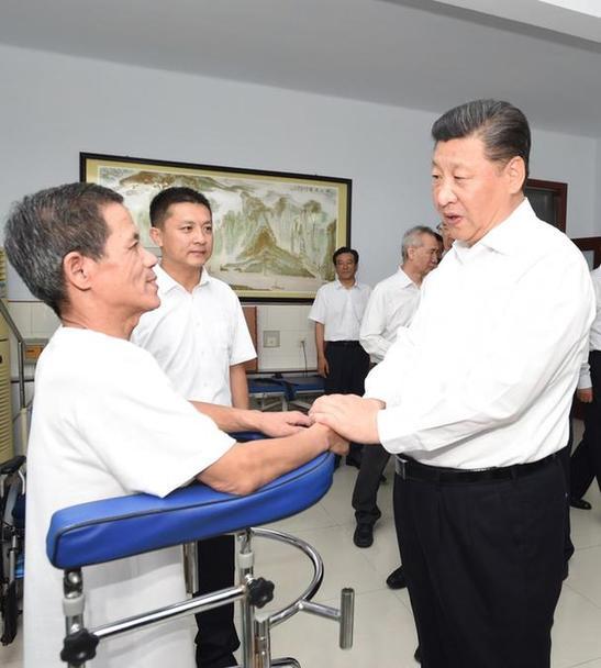 Chinese President Xi Jinping pays a visit to disabled people in Hebei Province on July 28, 2016. [File photo: Xinhua]