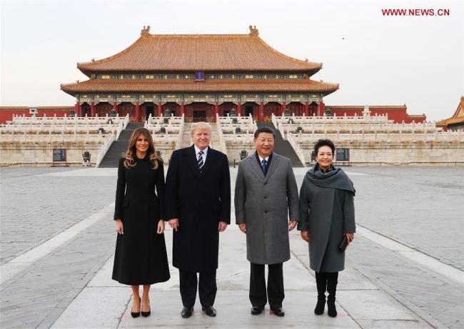 Chinese President Xi Jinping and his wife Peng Liyuan, and U.S. President Donald Trump and his wife Melania Trump pose for a photo in front of Taihedian, the Hall of Supreme Harmony, during their visit to the Palace Museum, or the Forbidden City, in Beijing, capital of China, Nov. 8, 2017. [Photo: Xinhua]