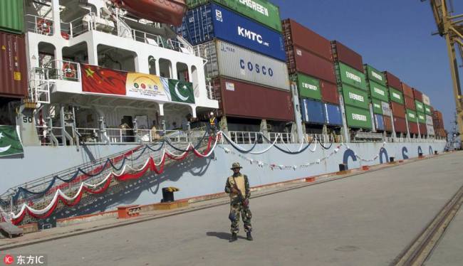 Pakistani Navy stand guard as a loaded Chinese ship prepares to depart from Gwadar Port that links China's far western region on a new international route exporting goods into the Middle East and Africa. [Photo: IC]