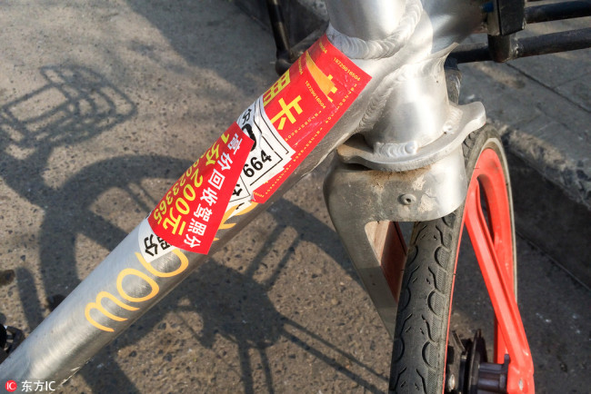 A Mobike shared bike covered with advertising stickers in Xi'an, northeast China's Shaanxi Province, on December 8, 2017. [Photo: IC]