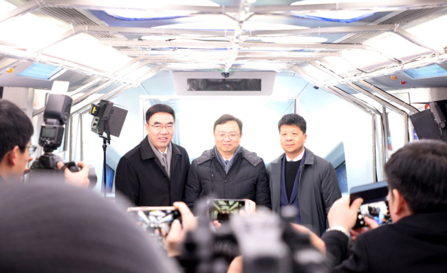 BYD Chairman and President Wang Chuanfu (left), Vice-President of Huawei Guo Ping (center) and acting Mayor of Yinchuan Yang Yujing (right) board SkyRail in Yinchuan, capital of Ningxia Hui Autonomous Region, January 10, 2018. [Photo provided to China Plus]