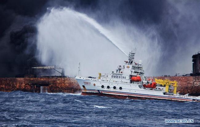 Rescuers spray foam to extinguish flames on the stricken oil tanker Sanchi off the coast of east China’s Shanghai, Jan. 12, 2018. [Photo: Xinhua]