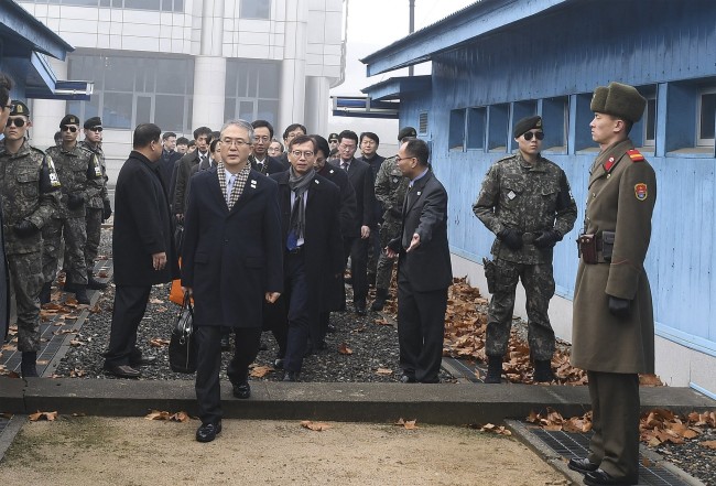 South Korean chief delegate Lee Woo-sung (front, C) and delegates head to the North Korea side of the border to attend a meeting, in the truce village of Panmunjom, North Korea, 15 January 2018.