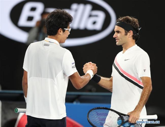 Chung Hyeon(L) of South Korea shakes hands with Roger Federer of Switzerland after the men's semifinal match at Australian Open 2018 in Melbourne, Australia, Jan. 26, 2018. Chung retired from the match due to injury. [Photo: Xinhua]
