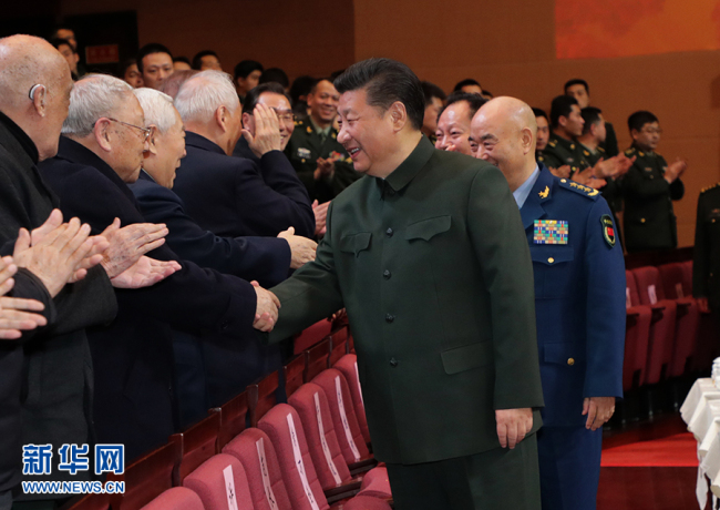 Chinese President Xi Jinping shakes hands with military veterans at a performance for retired military officials and veterans in Beijing on Friday, February 2, 2018. [Photo: Xinhua]