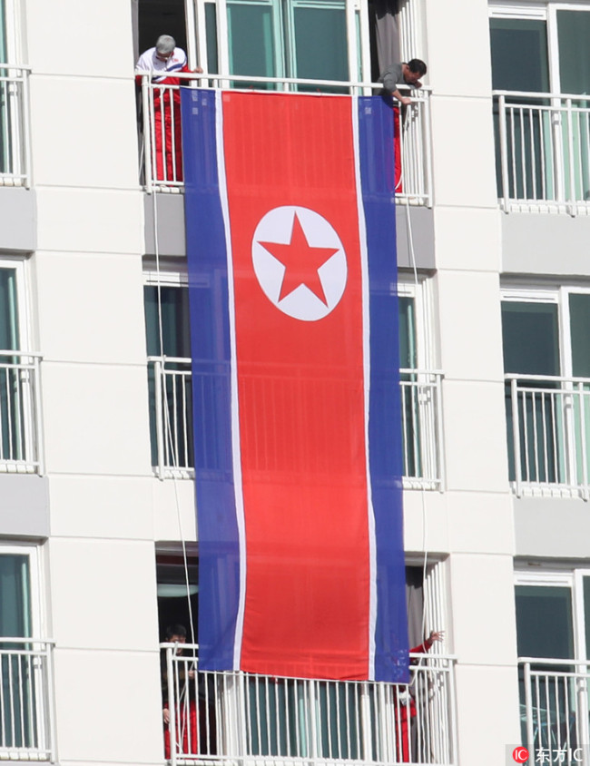 The North Korean flag decorates the facade of the accommodation of the North Korean Olympic team in the Olympic village in Pyeongchang, South Korea, 2 February 2018. [Photo: IC]