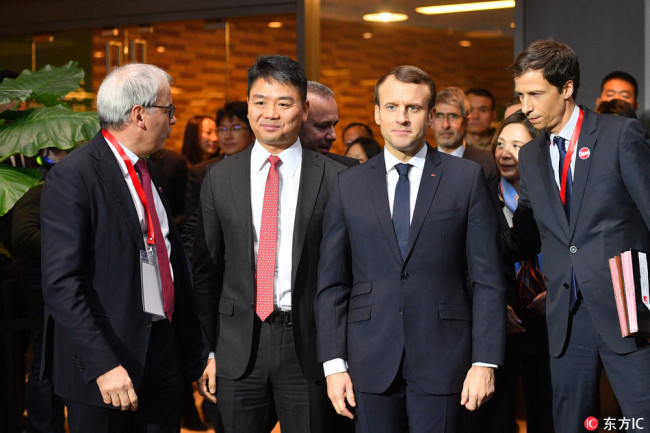 French President Emmanuel Macron poses with JD.com CEO Richard Liu Qiangdong during a meeting with business leaders at start-up incubator Soho3Q in Beijing, China, on January 9, 2018. [Photo: IC]