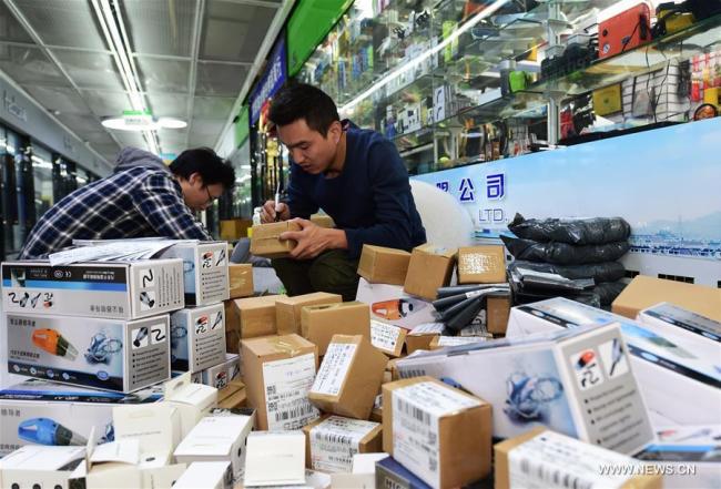 Staff members of an e-commerce company package products in Yiwu, east China's Zhejiang Province, Nov. 8, 2017. [Photo: Xinhua/Gong Xianming]
