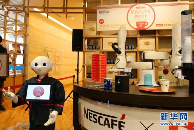 A robot greets customers at the café. [Photo: Xinhua]