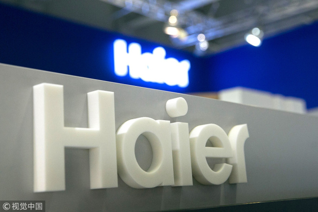 A Haier logo sits on display on the Qingdao Haier Co., Ltd. exhibition stand during the IFA International Consumer Electronics Show in Berlin, Germany, on Thursday, Sept. 1, 2016. [File Photo: VCG]