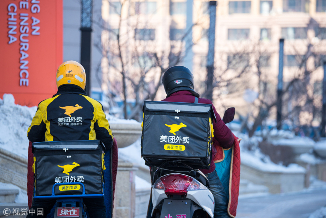 Food delivery couriers at work in minus 23 degrees Celsius weather in Harbin, capital of northeast China's Heilongjiang Province on January 18, 2018. [Photo: VCG]