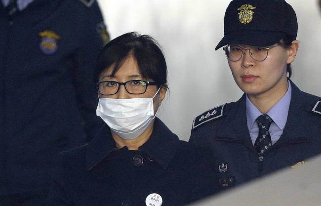 Choi Soon-sil, center, a confidante of former South Korean President Park Geun-hye, arrives at the Seoul Central District Court in Seoul, South Korea, Feb. 13, 2018. [Photo: AP/Ahn Young-joon]