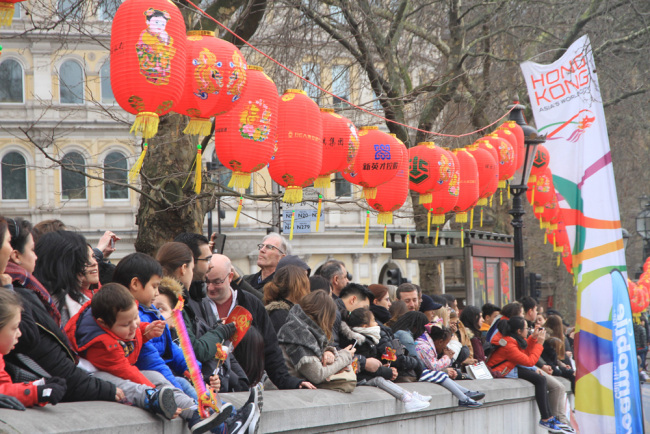 Local residents watch New Year performances at Trafalgar Square in London on February 18. [Photo: China Plus/Liang Tao]