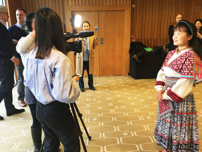 One member of the Xiaoshuijing Farmer's Choir takes questions during an interview after the choir’s dress rehearsal at London’s Royal Festival Hall on Friday, February 23, 2018. [Photo: China Plus/Duan Xuelian]