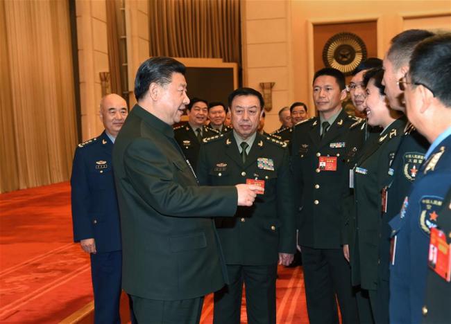 Chinese President Xi Jinping, also chairman of the Central Military Commission, speaks to national lawmakers from the People's Liberation Army (PLA) at the ongoing annual parliamentary session on Sunday, March 12, 2017. [Photo: Xinhua]