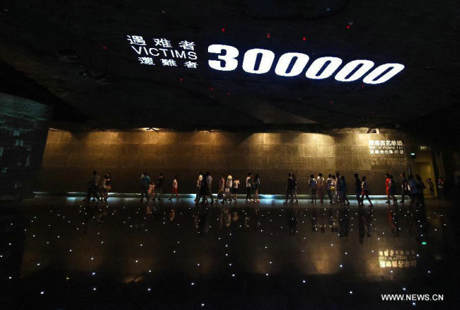 People visit the memorial hall of the victims of the Nanjing Massacre by Japanese invaders in Nanjing, capital of east China's Jiangsu Province. [File photo: Xinhua]