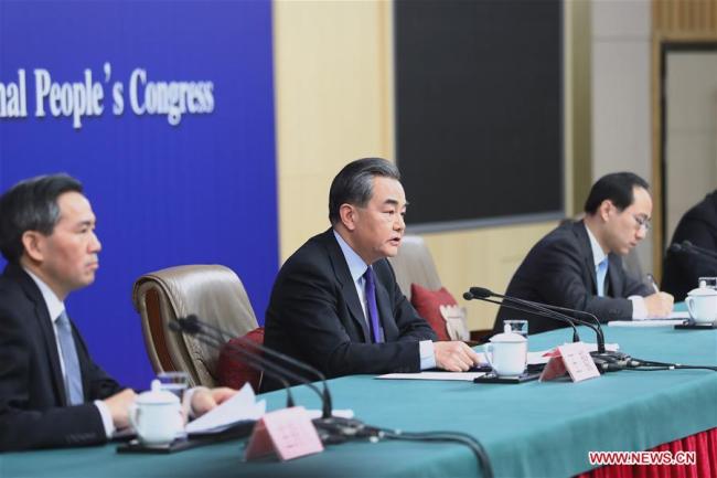 Chinese Foreign Minister Wang Yi (C) answers questions on China's foreign policies and foreign relations at a press conference on the sidelines of the first session of the 13th National People's Congress in Beijing, capital of China, March 8, 2018. [Photo: Xinhua] 