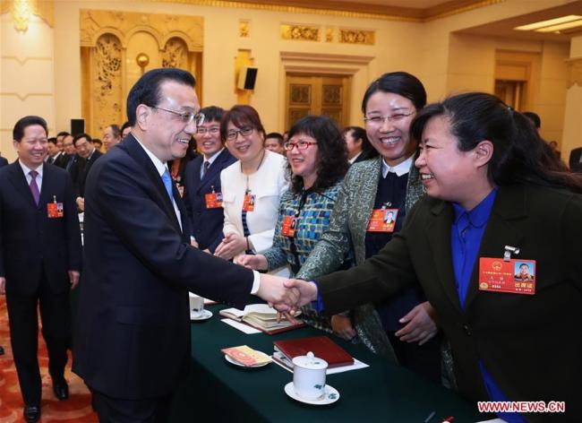 Chinese Premier Li Keqiang, who is also a member of the Standing Committee of the Political Bureau of the Communist Party of China (CPC) Central Committee, joins a panel discussion with the deputies from Liaoning Province at the first session of the 13th National People's Congress in Beijing, capital of China, March 8, 2018. [Photo: Xinhua/Ju Peng]
