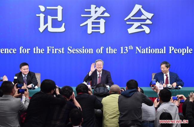 Zhou Xiaochuan (C), governor of the People's Bank of China (PBOC), Yi Gang (R), deputy governor of the PBOC and Pan Gongsheng, deputy governor of the PBOC and head of the State Administration of Foreign Exchange, attend a press conference on financial reform and development on the sidelines of the first session of the 13th National People's Congress in Beijing, capital of China, March 9, 2018. [Photo: Xinhua/Li Xin]