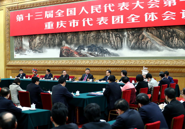 Chinese President Xi Jinping, also general secretary of the Communist Party of China (CPC) Central Committee and chairman of the Central Military Commission, joins a panel discussion with deputies from Chongqing Municipality at the first session of the 13th National People's Congress in Beijing on Saturday, March 10, 2018. [Photo: Xinhua]