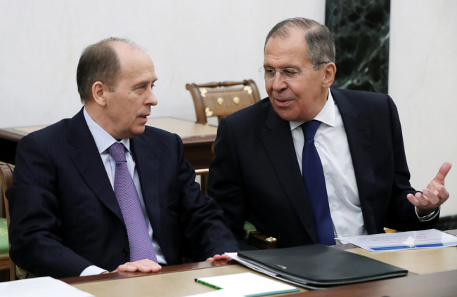 Russian Foreign Minister Sergey Lavrov speaks to Federal Security Service (FSB) Director Alexander Bortnikov as they attend a security council meeting in the Kremlin in Moscow on March 15, 2018. Lavrov said Thursday that Moscow would "certainly" expel some British diplomats in a tit-for-tat response. In remarks carried by the RIA Novosti news agency, Lavrov said the move would come "soon." [Photo: AP]