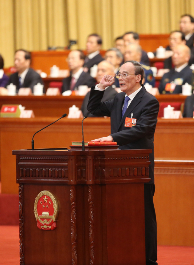 Wang Qishan takes a public oath of allegiance to the Constitution in the Great Hall of the People in Beijing on March 17, 2018. Wang Qishan was elected vice president of China on Saturday at the annual session of the country's top legislature. [Photo: Xinhua]