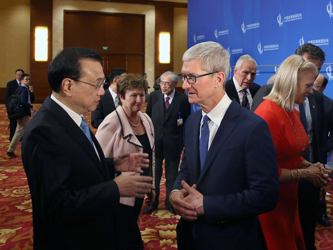 Chinese Premier Li Keqiang talks with Apple CEO Tim Cook at the China Development Forum in Beijing on March 26, 2018. [Photo: gov.cn]