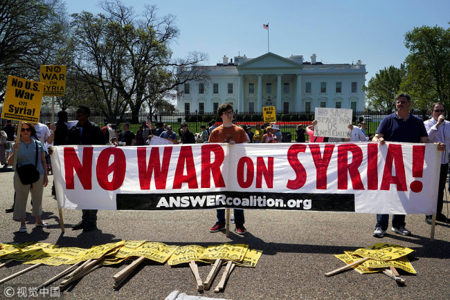 Demonstrators protest after the missile strikes on Syria, outside the White House in Washington, U.S., April 14, 2018. [Photo: VCG]
