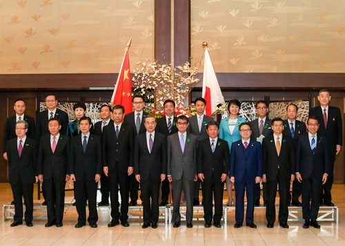 Chinese State Councilor and Foreign Minister Wang Yi, Japanese Foreign Minister Taro Kono, as well as senior officials of foreign affairs, economic and finance ministries of both countries pose a group photo in Tokyo on April 16, 2018. [Photo: fmprc.gov.cn]