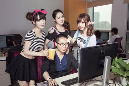 Undated photo shows three programmer motivators helping a coder relieve stress at an IT company in Chongqing. [File photo: gmw.cn]