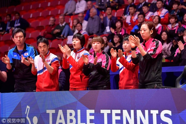 Korean staff and players from the DPRK and ROK applaud during the women's semifinal as Korea came up against Japan at the World Team Table Tennis Championships 2018 in Halmstad, Sweden, on Friday, May 4, 2018. [Photo: VCG]