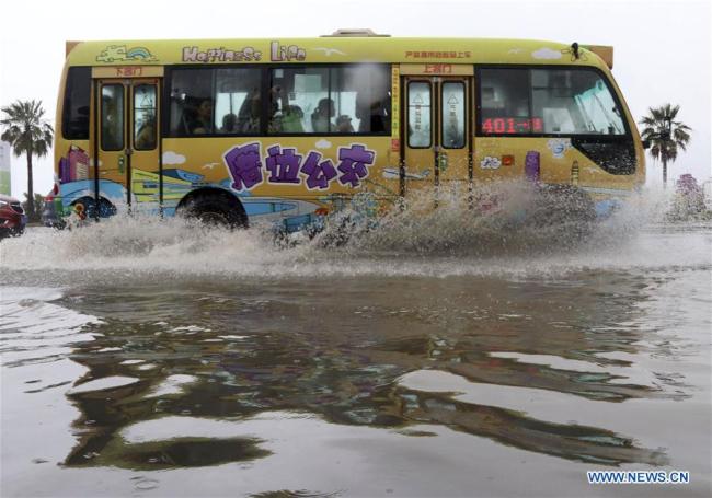 A bus drives on a flooded road in Xiamen, southeast China's Fujian Province, May 7, 2018. 