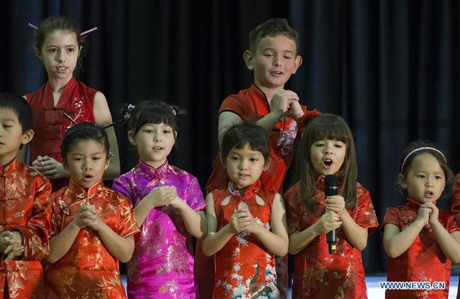 A crowd of 2,000 at Houston school gets into the Chinese New Year spirit during the third annual celebration performance, in Awty International School, Houston, Texas, in March. [Photo: Xinhua]