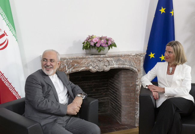 European Union foreign policy chief Federica Mogherini, right, meets with Iranian Foreign Minister Javad Zarif prior to a meeting of the E-3 and Iran at the Europa building in Brussels on Tuesday, May 15, 2018. [Photo: AP]