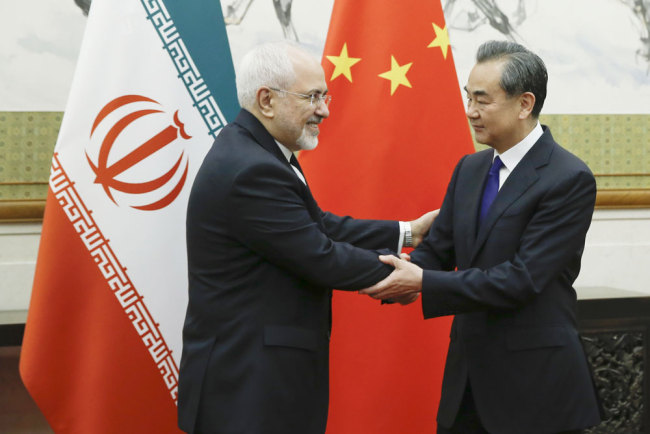 Chinese State Councillor and Foreign Minister Wang Yi meets Iranian Foreign Minister Mohammad Javad Zarif at Diaoyutai state guesthouse in Beijing, Sunday, May 13, 2018.[Photo: AP]