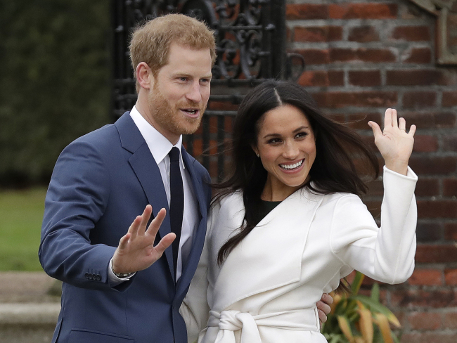 Britain's Prince Harry and Meghan Markle pose for photographs during a photo-call on the grounds of Kensington Palace in London, November 27, 2017. [Photo: AP]