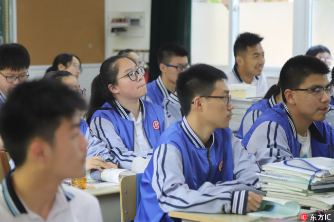Students attend class in a classroom equipped with a facial-recognition camera at Hangzhou No. 11 High School, in Hangzhou, Zhejiang Province, on May 15, 2018. [Photo: IC]
