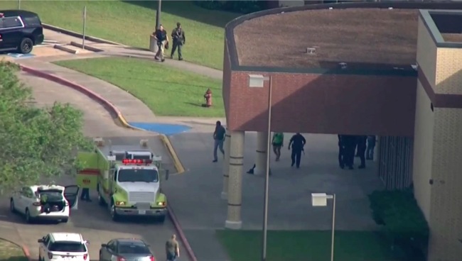 In this image taken from video law enforcement officers respond to a high school near Houston after an active shooter was reported on campus, Friday, May 18, 2018, in Santa Fe, Texas. The Santa Fe school district issued an alert Friday morning saying Santa Fe High School has been placed on lockdown. [Photo: AP]