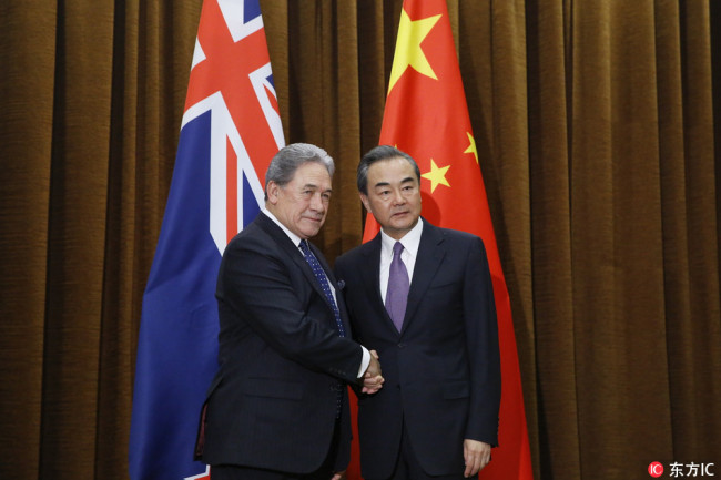 China's Foreign Minister Wang Yi (R) shakes hands with New Zealand's Foreign Minister Winston Peters (L) during their meeting in Beijing, China, May 25, 2018. [Photo: IC]